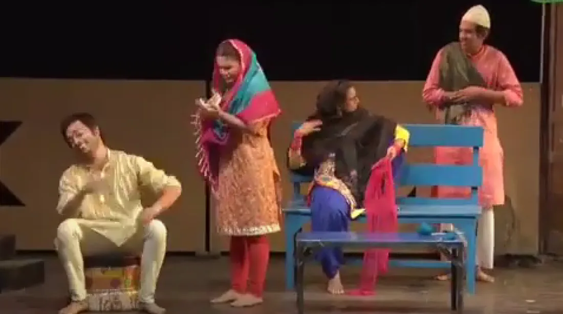 Ensemble cast performing a scene from a festival theatre production